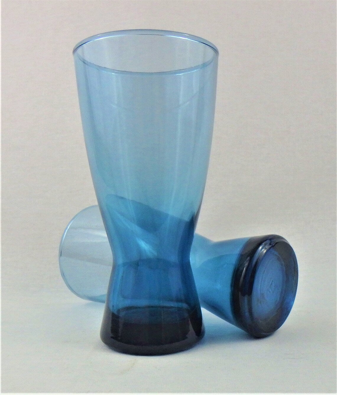 Blue drink glass on a light gray background