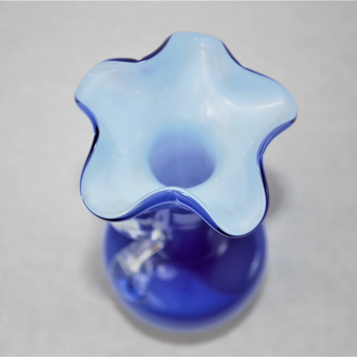 Blue star-shaped top of vase on a gray background