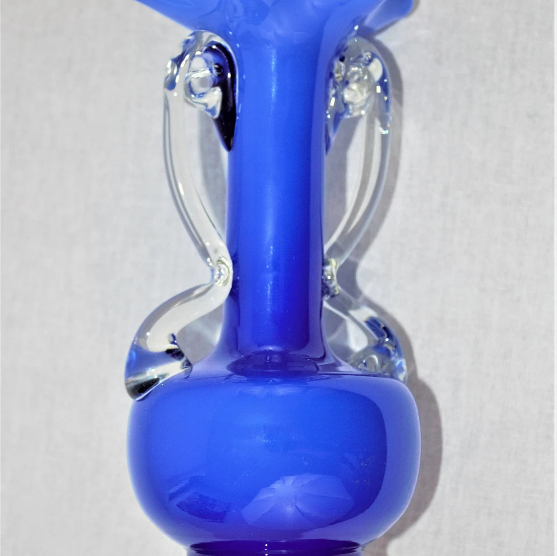 Blue glass vase on a white background