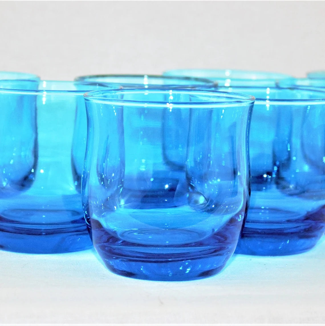 Set of blue glass tumblers on a white background