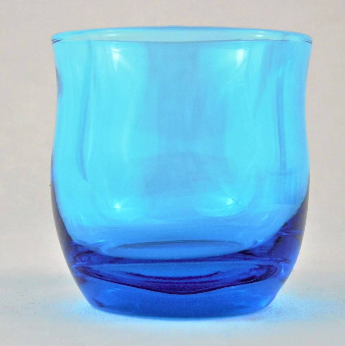 Blue glass on a light gray background