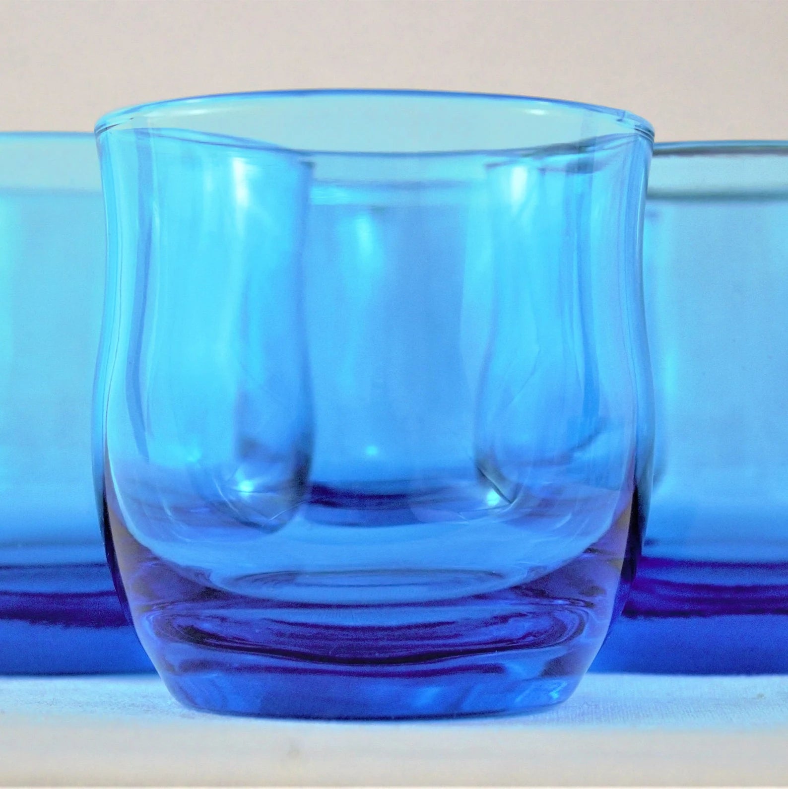 Blue glass tumbler on a light background